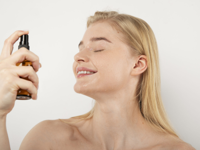 close-up-smiley-woman-using-product